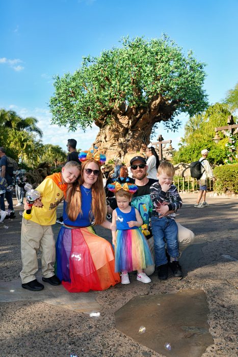 The whole family together in front of the Tree of Life at Disney