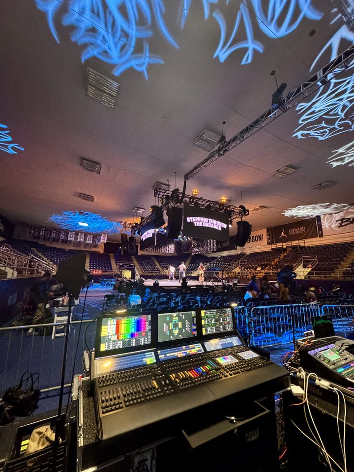 grandMA3 at front of house with blue gobos across an arena ceiling